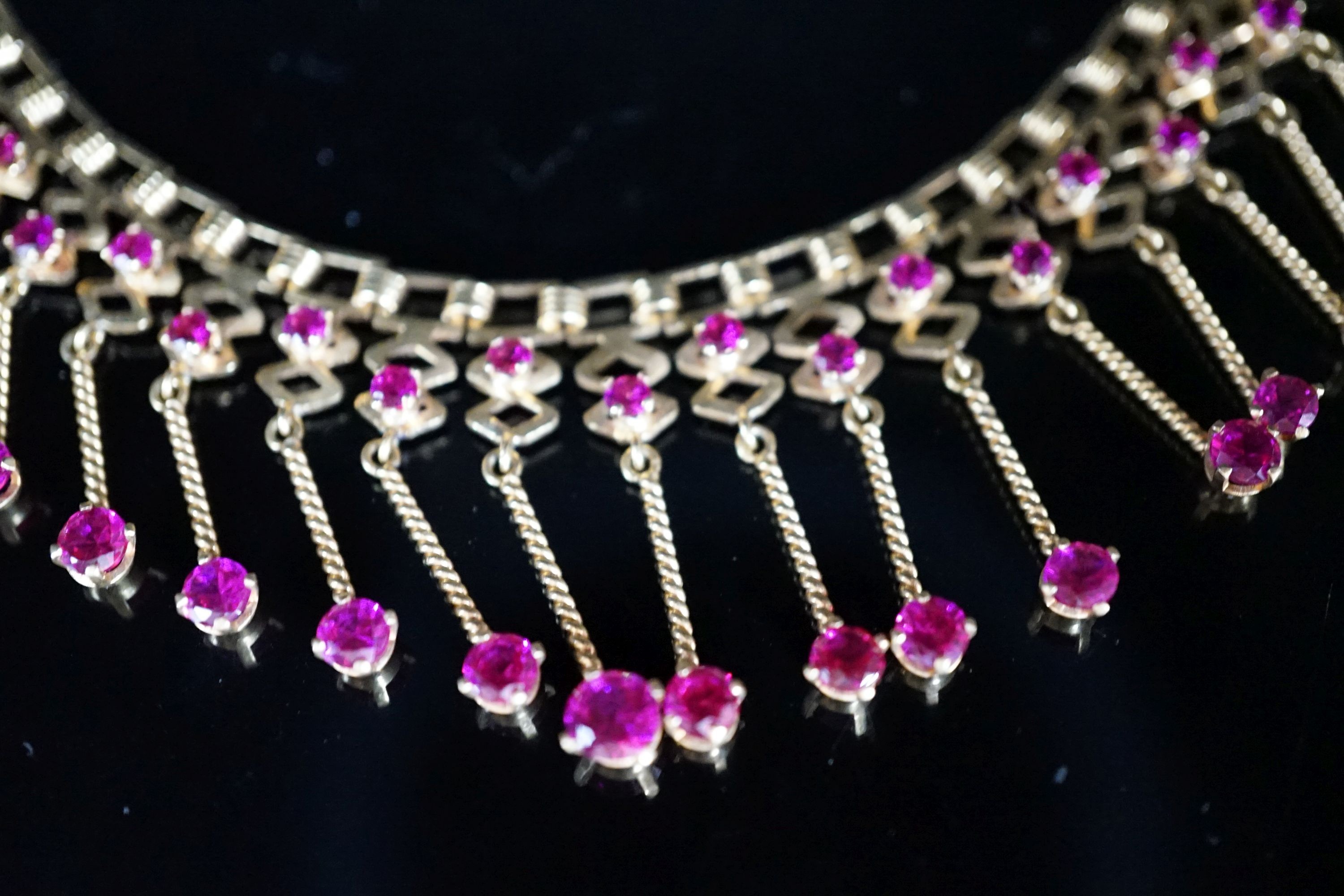 A modern yellow metal (stamped 18) and synthetic ruby? set drop fringe necklace, 41cm, gross 35 grams.